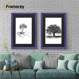 Framorey purple picture frames with black mounts hanging above a couch against a brick wall