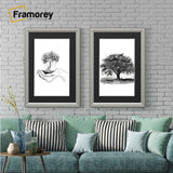 Two Silver picture frame with black mount hanged on a wall over the sofa set.