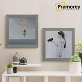 Two Step Style Square Grey Picture Frame Wall Art Poster Frame are hanging on a wall one after the other and the second frame is a little lower than the first frame.