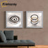 Two Square silver glitter poster frame hanged on a wall over the sofa.