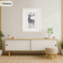 White Picture Frame With White Mount is hanging on a wall just over the Table