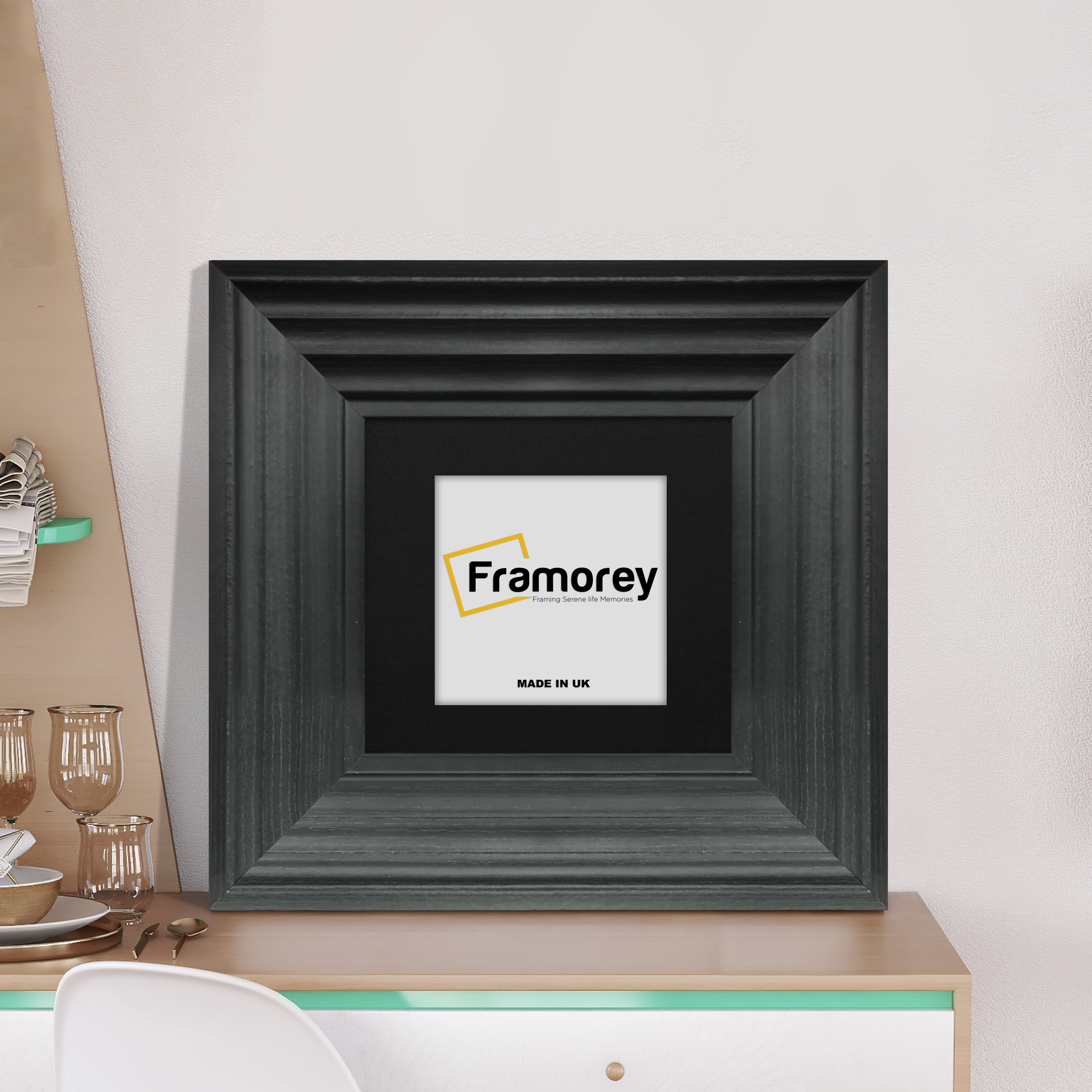 Big Step Style Black Wooden picture frame with black mount placed on a drawer.