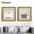 Two Square gold Ivory mount shabby photo frames hanged on a wall over the couch.
