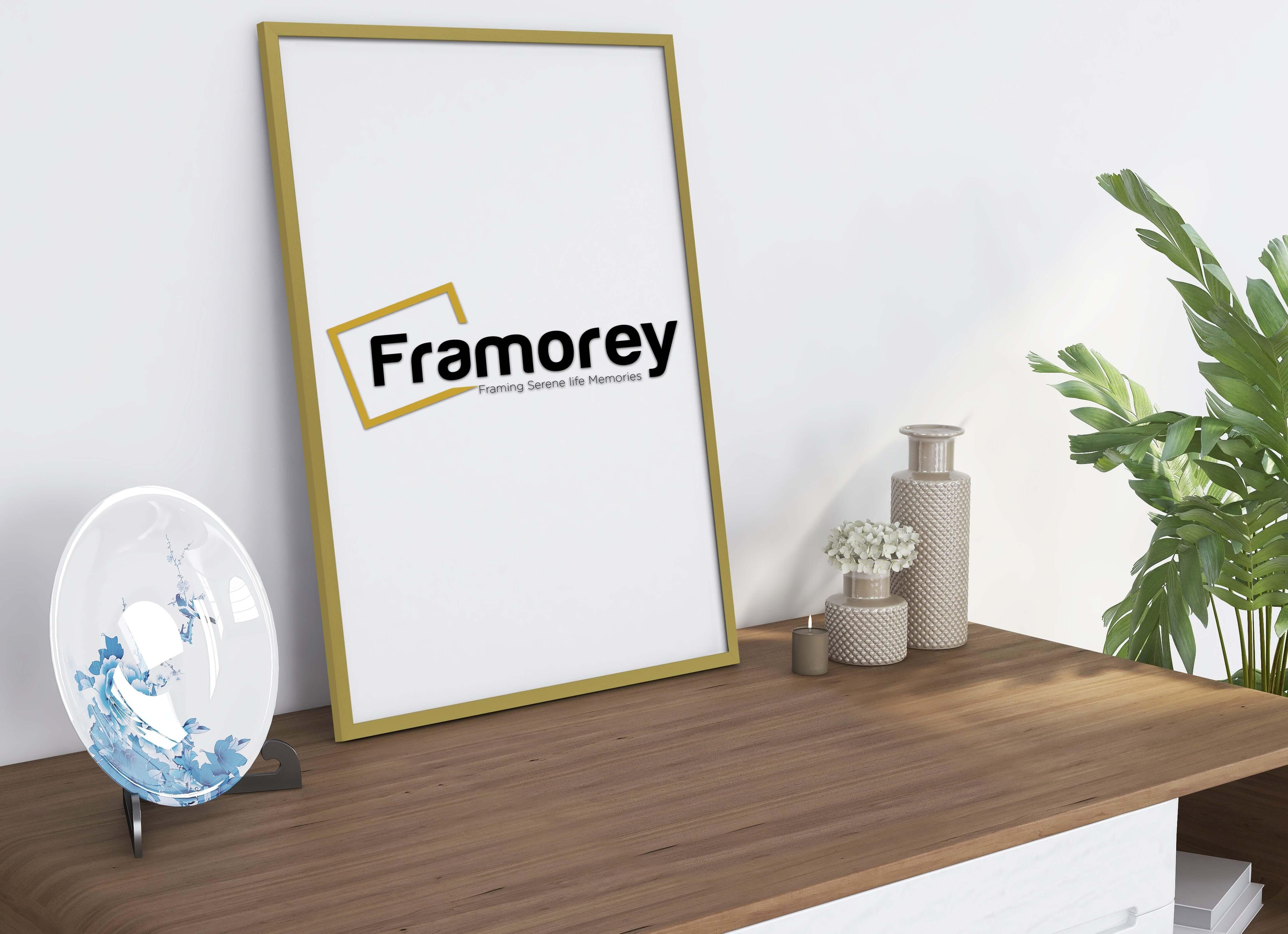 thin flat gold picture frame side view with a plate placed at its right. 